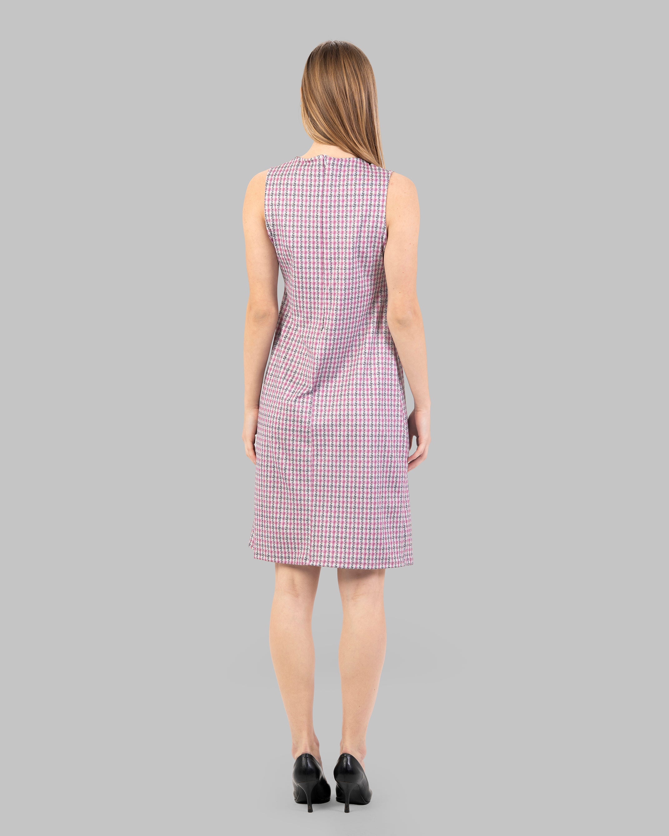 fitted dress with a pink and black houndstooth pattern.