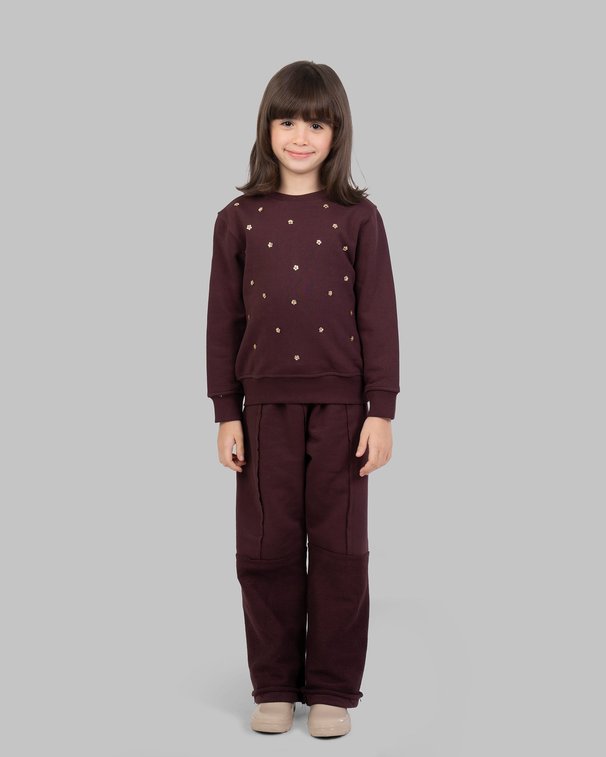 sweatshirt with small, scattered gold flowers on the front.