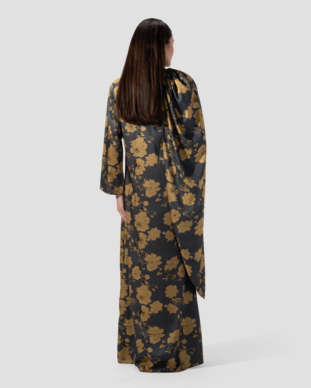 loose dress with a floral print of golden flowers .