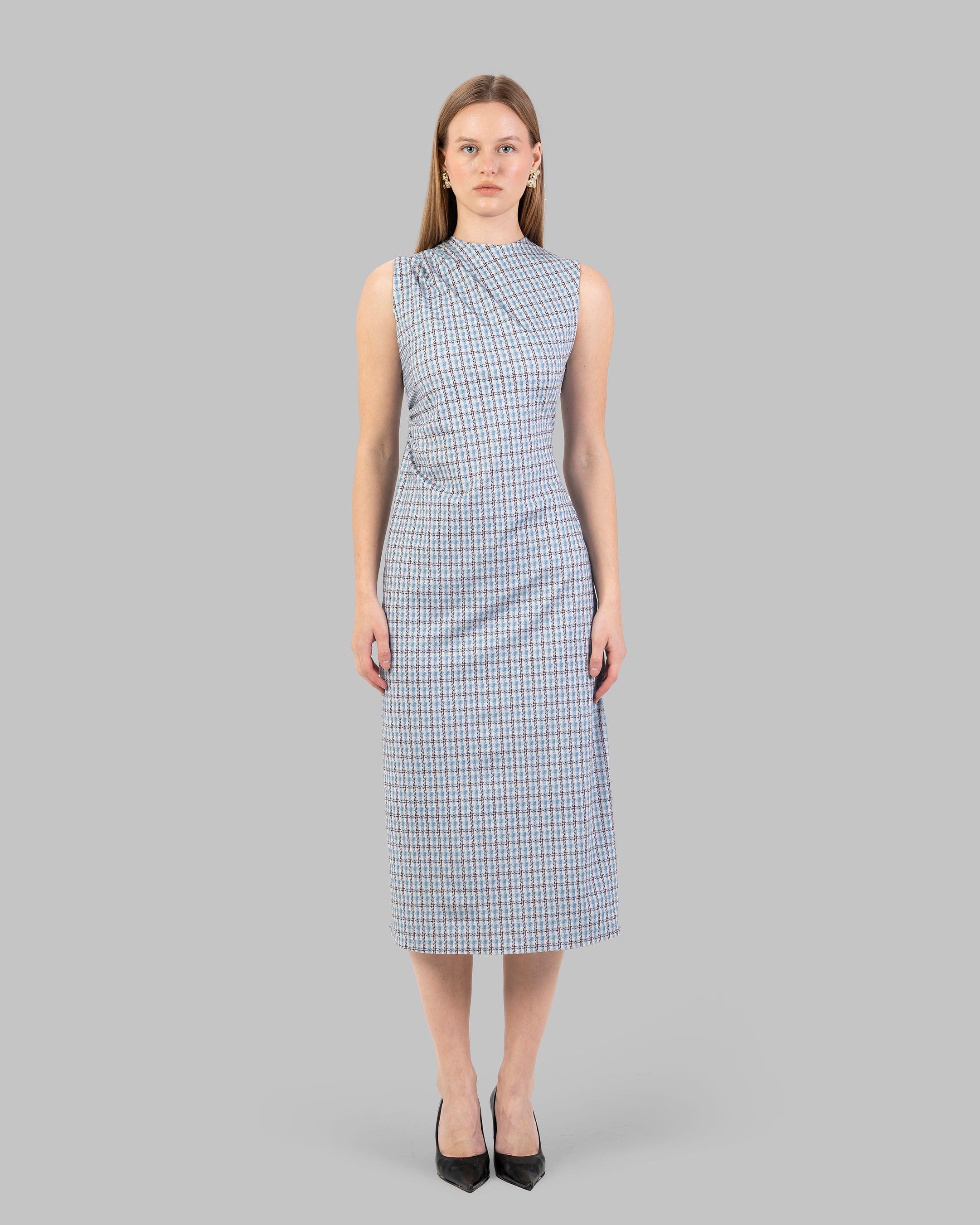 fitted dress with a pink and black houndstooth pattern.