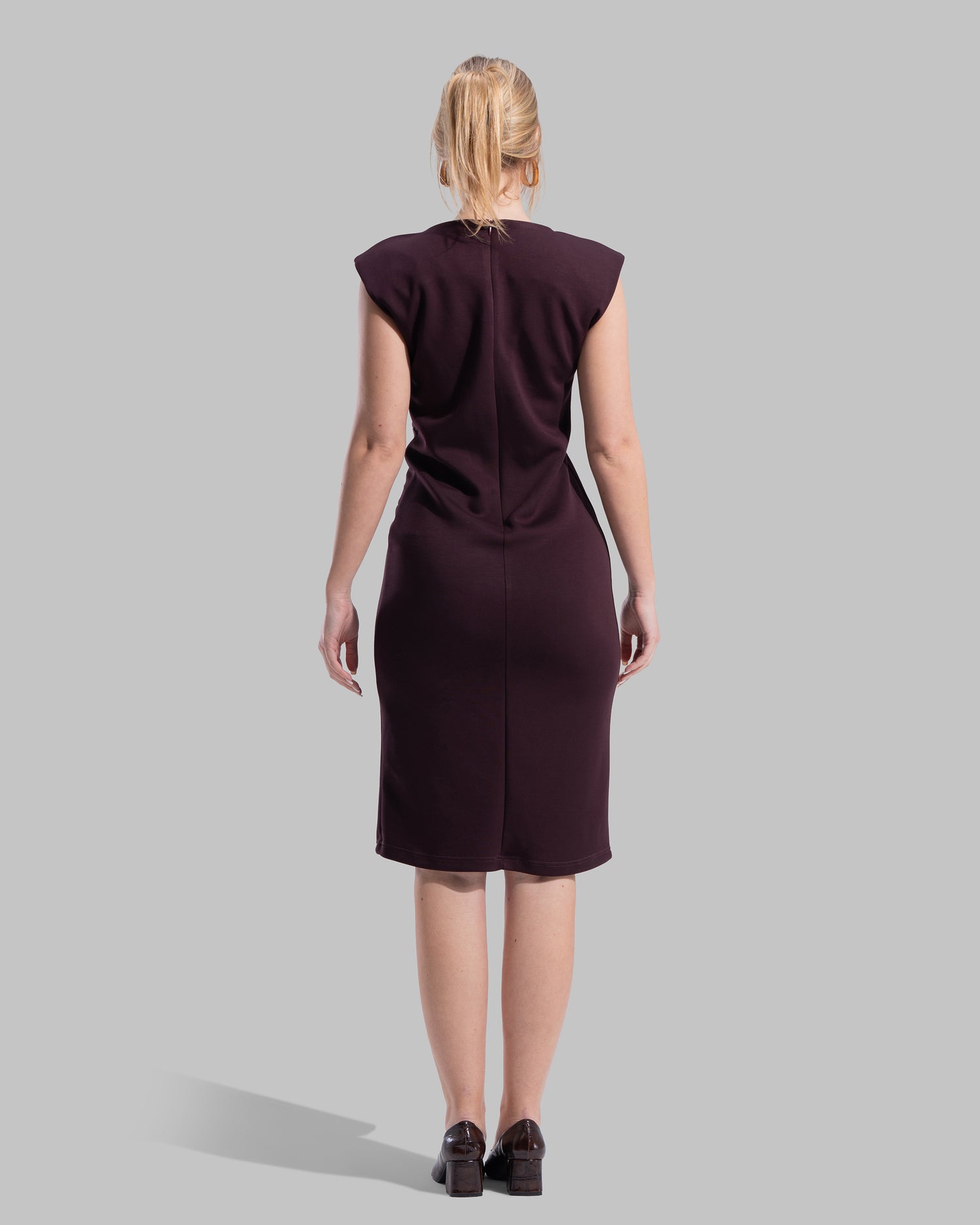 Sleeveless midi dress featuring a round neckline and front draped knot detail.
