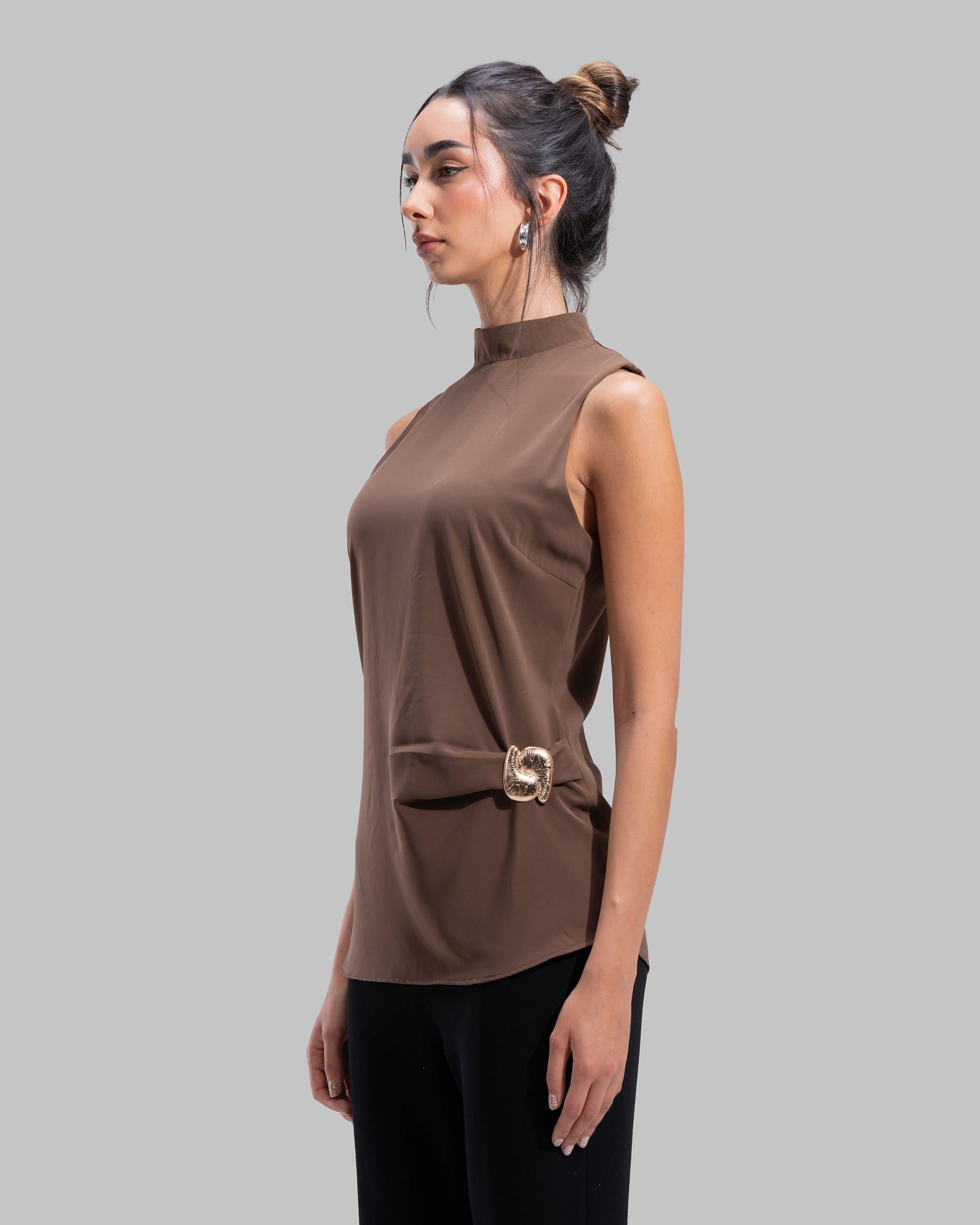 Sleeveless high-neck top with gathered detail and a metallic side buckle.