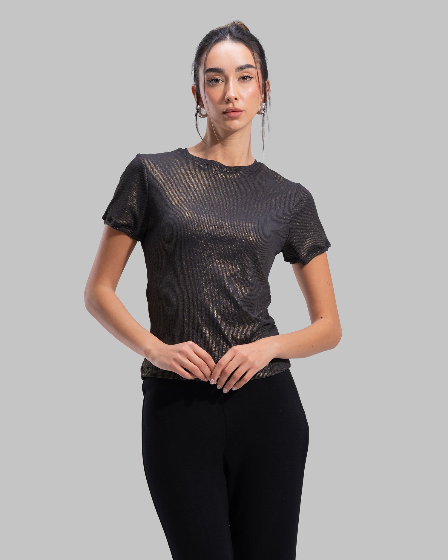 Short sleeve ribbed top with a shimmering metallic finish and round neck.
